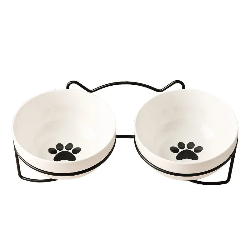 White ceramic cat bowl with decorative patterns on iron frame with cat ear details