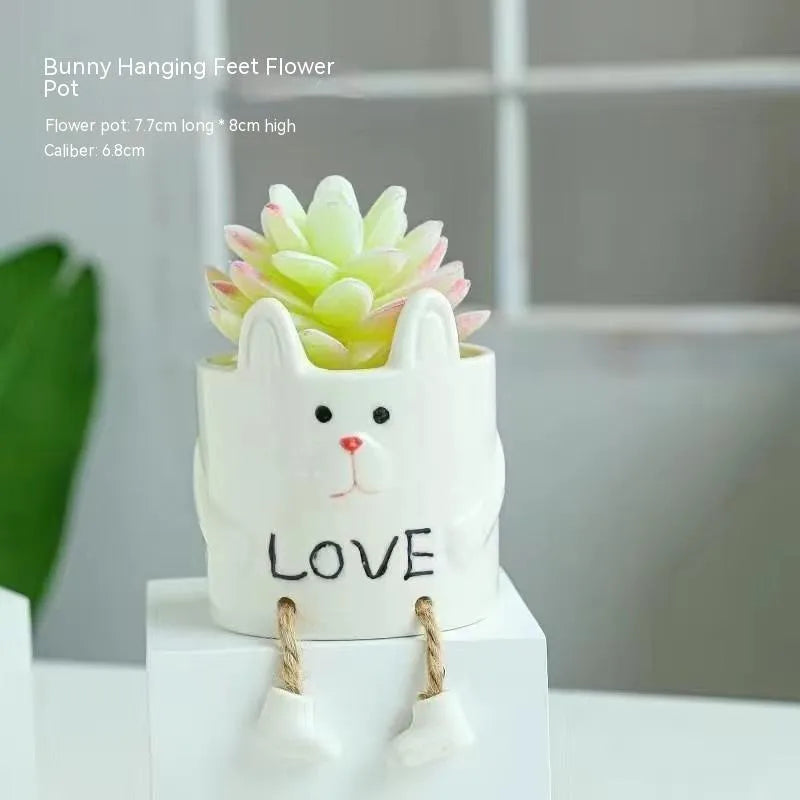 Cartoon style ceramic hanging foot flowerpot for succulent plants on a desktop.