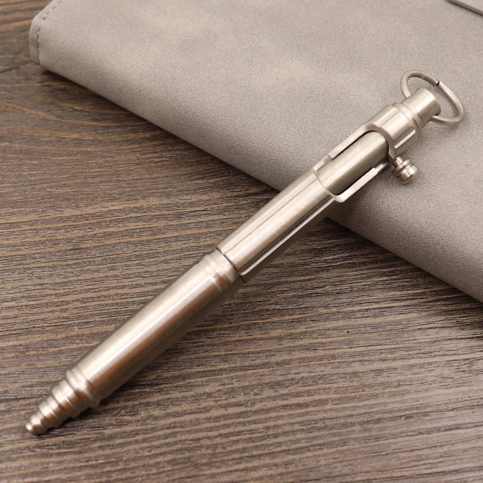 Retro brass tactical pen with cylindrical barrel and six-ring grip, shown with press mechanism extended