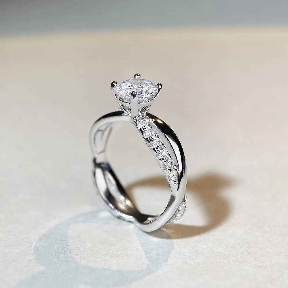 Geometric twisted arm silver ring with 1 karat moissanite centre stone in four-claw setting