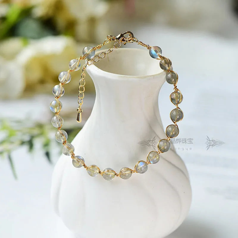 Women's blue moonstone bracelet with 6mm crystal and 14K gold-plated gilded metal band.