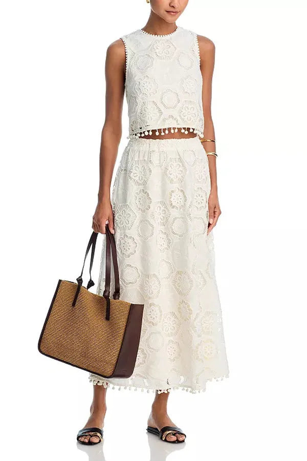 White women's retro style suit with sleeveless top, embroidered long skirt on hanger