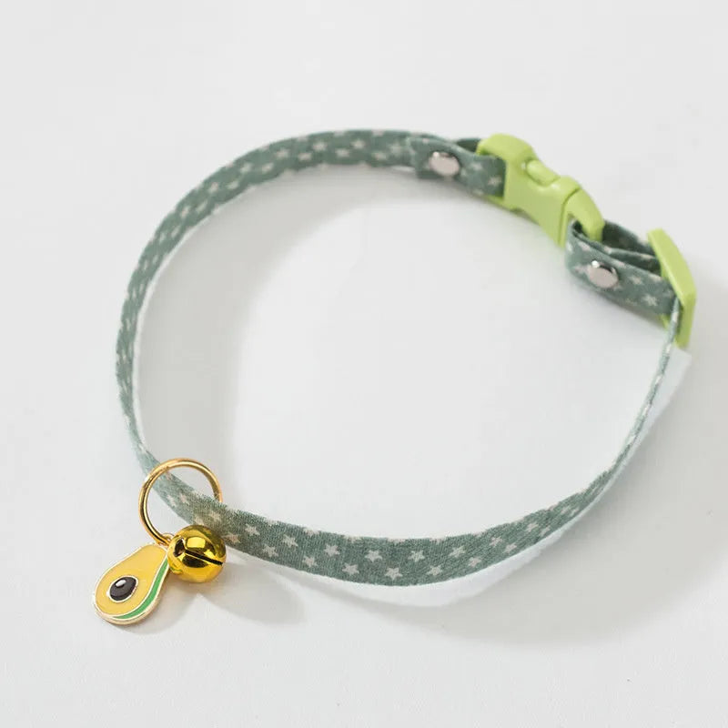 Adjustable green cat collar with a metal bell and a matching bow tie for small pets.