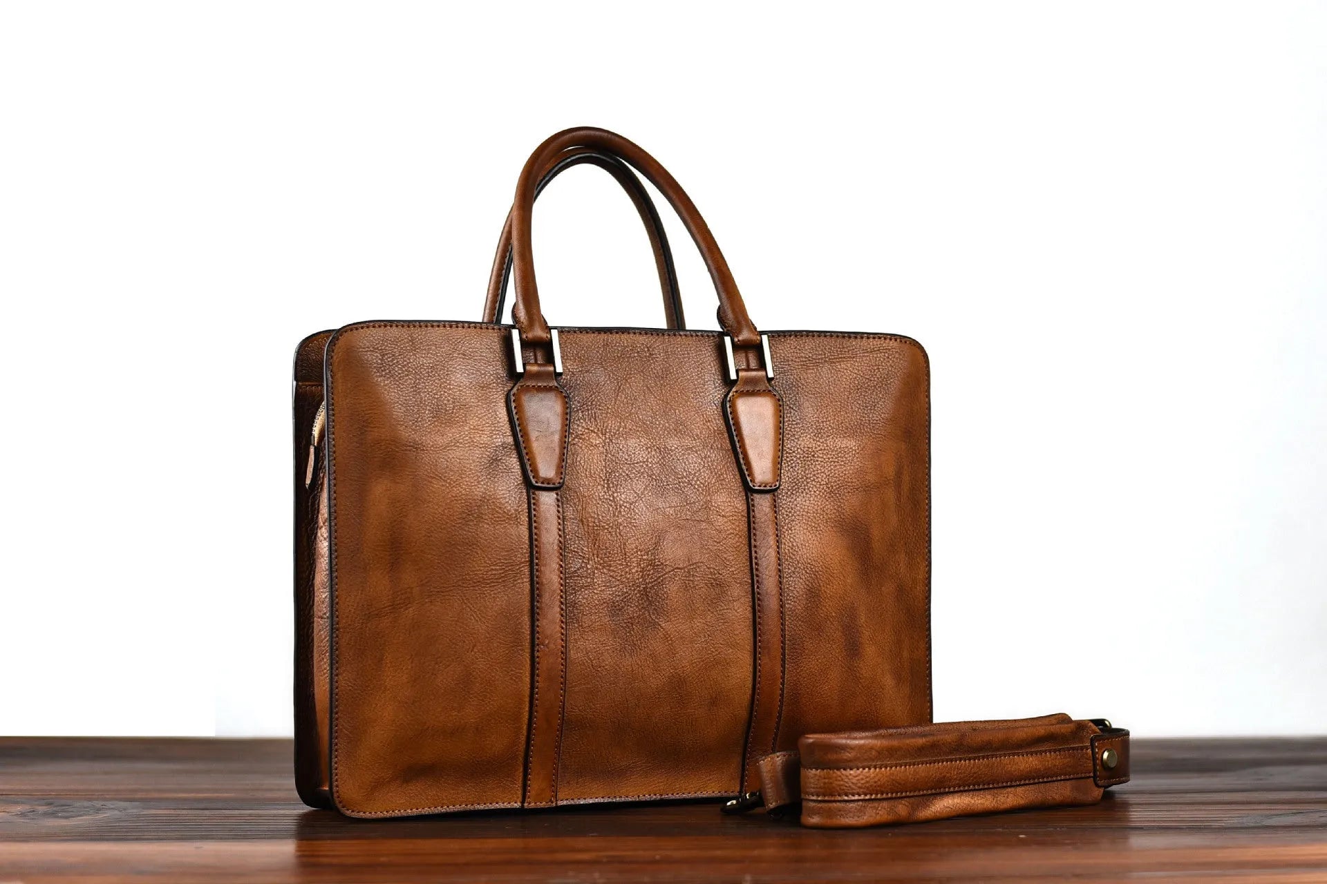 Men's brown leather horizontal business handbag with zip opening showing 14-inch size