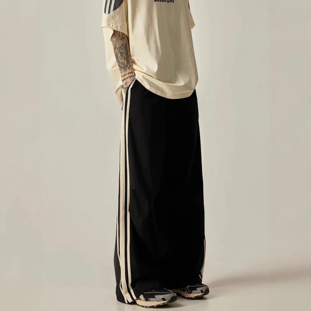 Black high-waisted wide-leg polyester climbing trousers for men laid flat.