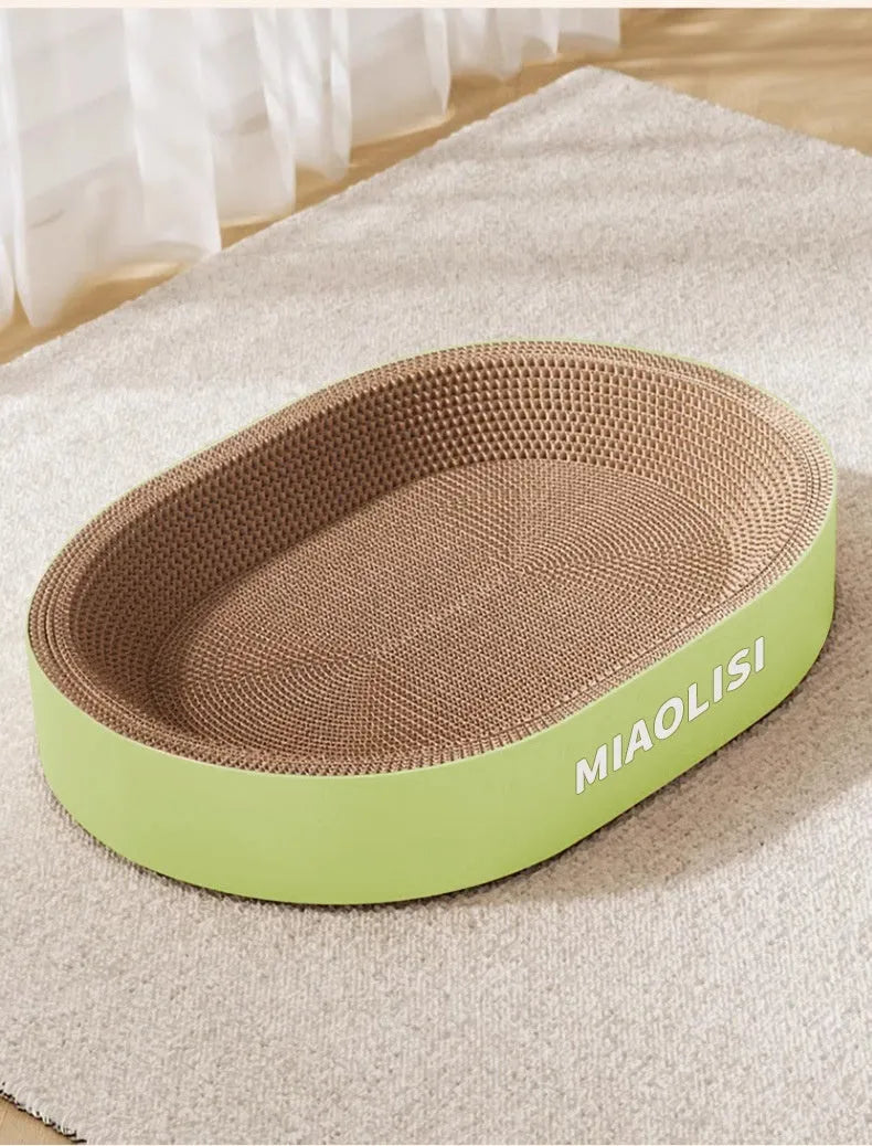 Green oval corrugated paper cat scratch board and nest bed showing 55cm diameter.