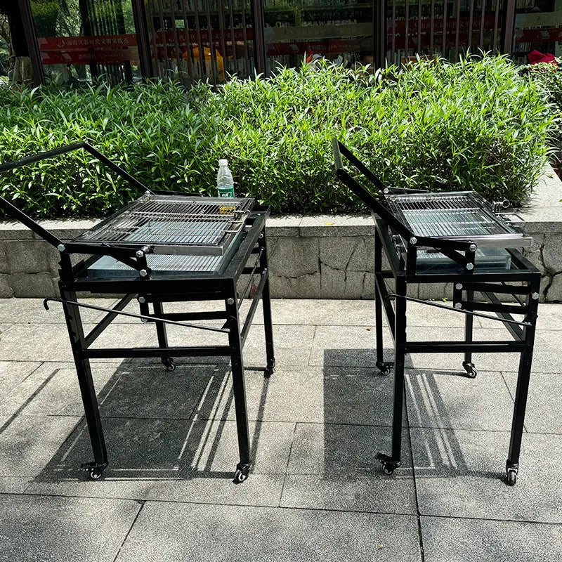 Large foldable portable charcoal grill oven set up in a garden