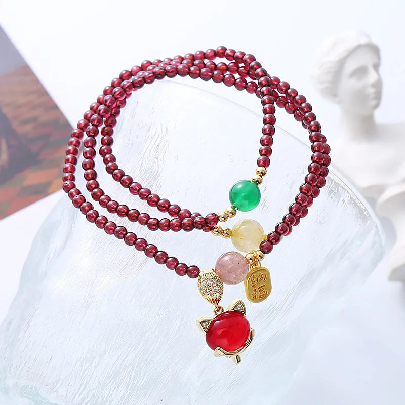 Women's adjustable garnet fox bracelet with rope closure in purplish red colour