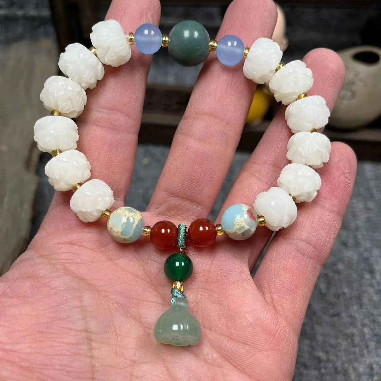 Carved pumpkin and lotus bead bracelet made from Bodhi root with white jade and aventurine details.