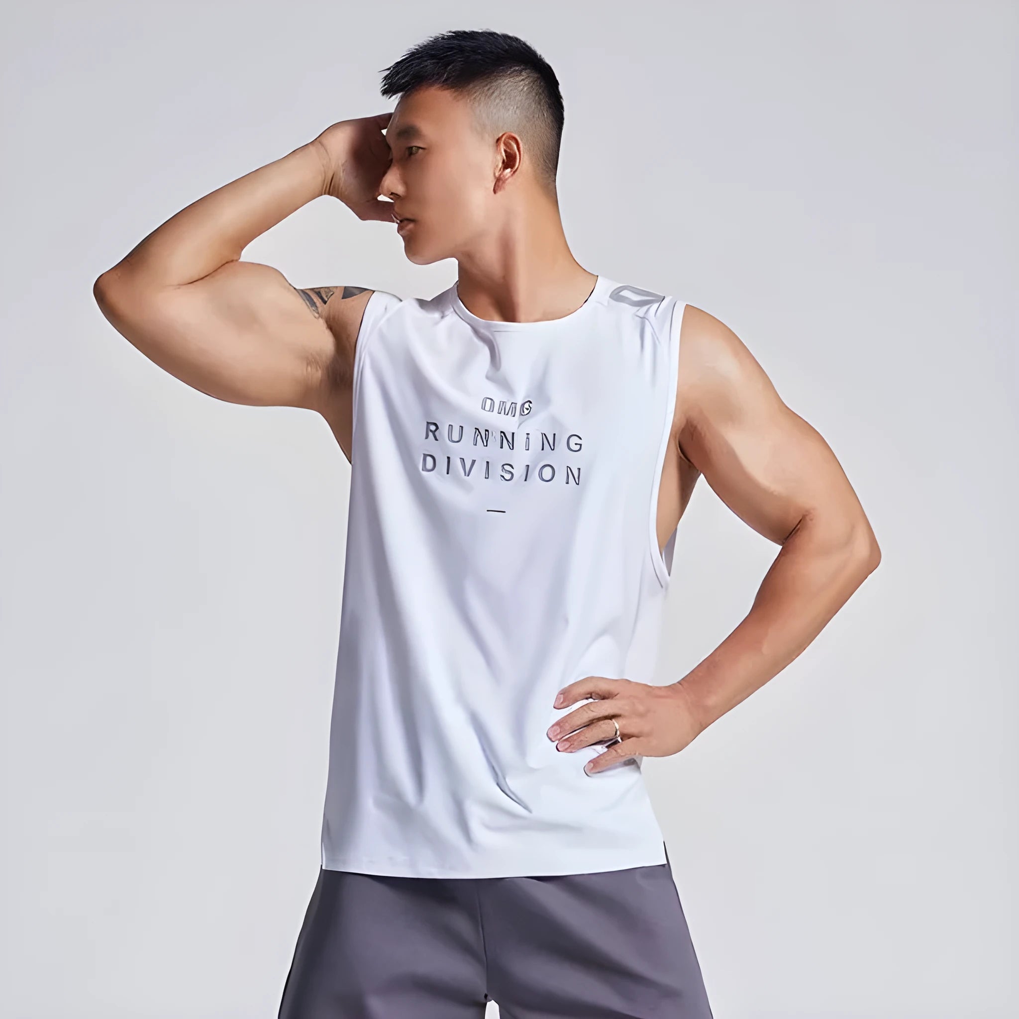 Man wearing a lightweight grey mesh sports vest, showing loose fit and breathable fabric for exercise.
