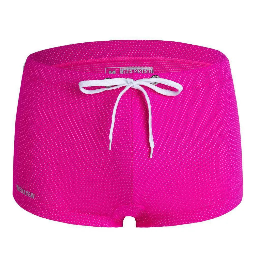 Men's low waist boxer style nylon swimming trunks in multiple solid colours