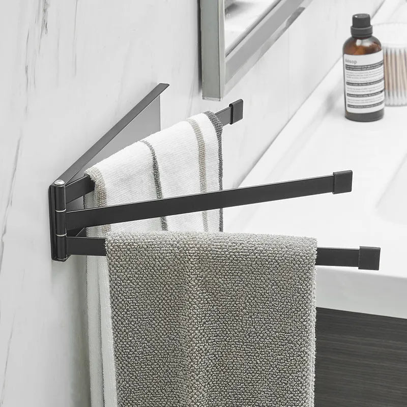 Nordic folding towel bar in black mounted on bathroom wall with towels hanging