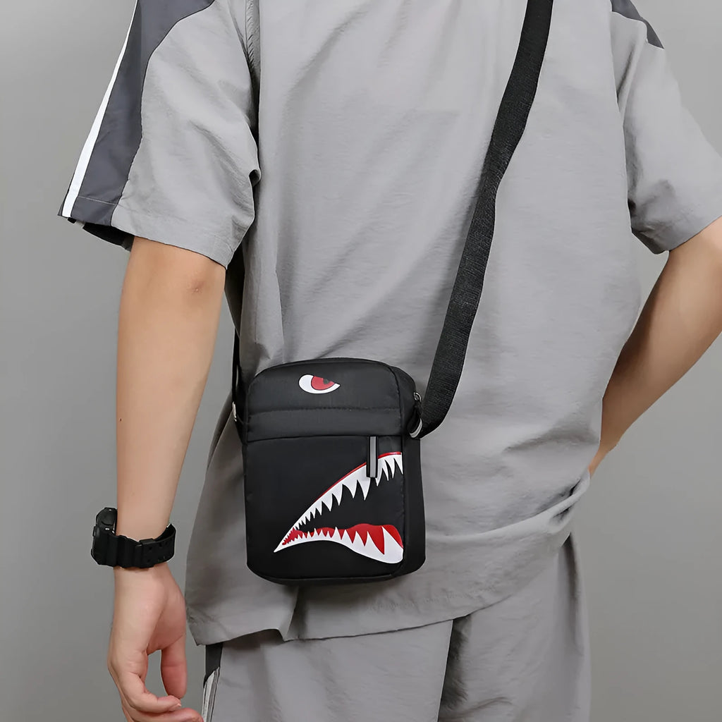 Men's small black Oxford cloth crossbody bag with animal print pattern and shoulder strap.