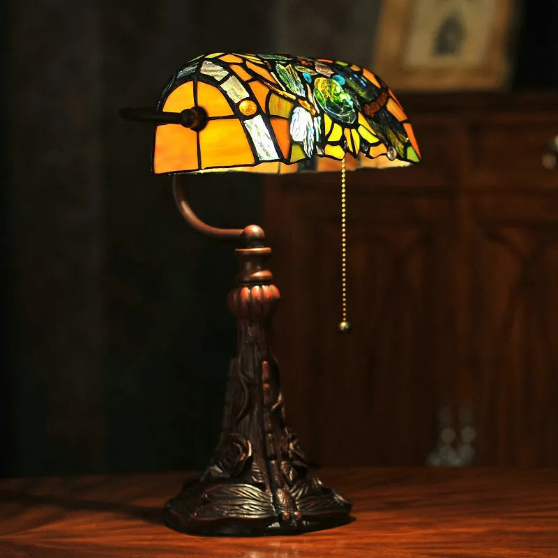 10-inch Tiffany table lamp with coloured stained glass resin shade on a desk.
