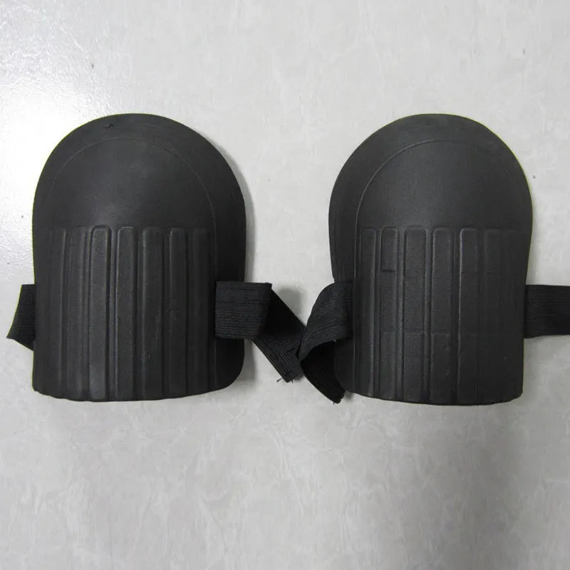 A pair of thick EVA foam knee pads in army green colour on grass.
