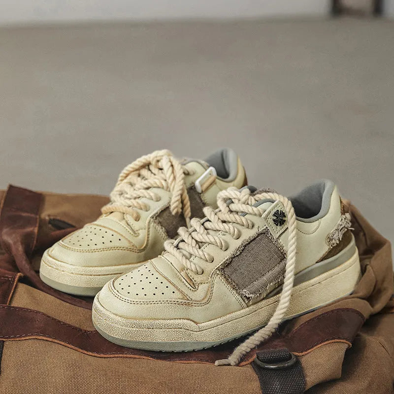Beige low-top casual skateboard shoes with round toe and front lace-up on a rubber sole.