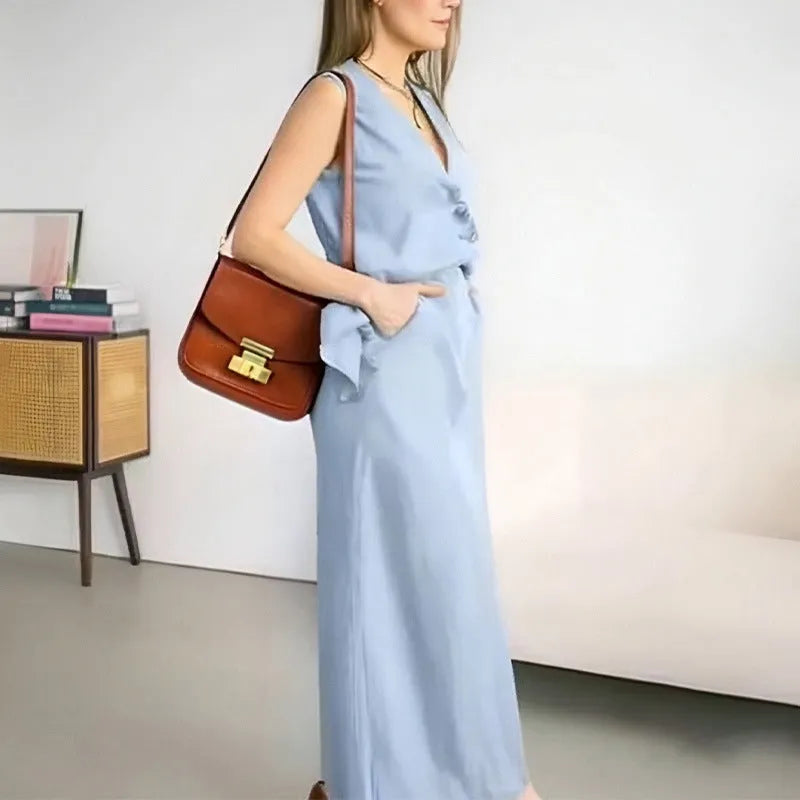 Women's loose fit blue polyester two-piece suit with sleeveless vest and long skirt.