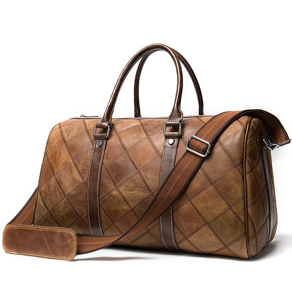Vintage brown cowhide leather men's duffel bag with a single shoulder strap, shown open to reveal internal phone pocket and zippered compartment.