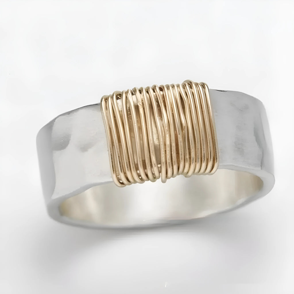 Geometric copper bracelet with irregular coil pattern forming silver-gold wide-faced ring design