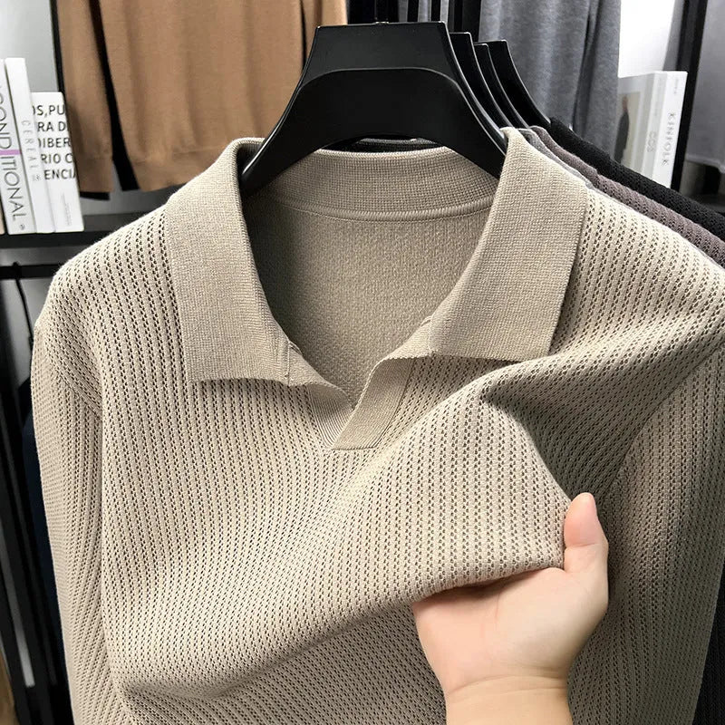 A man's loose-fitting casual pullover jumper in a neutral colour, shown on a model.