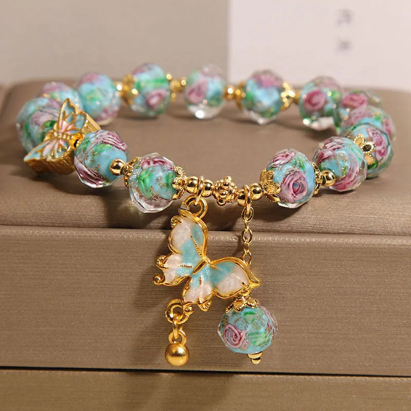 Women's rose garden bracelet with coloured glaze butterfly charm in blue, Japanese Korean style
