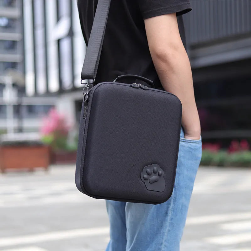 Nintendo Switch cat claw storage bag with shoulder strap, shown in black, holding game cartridges.