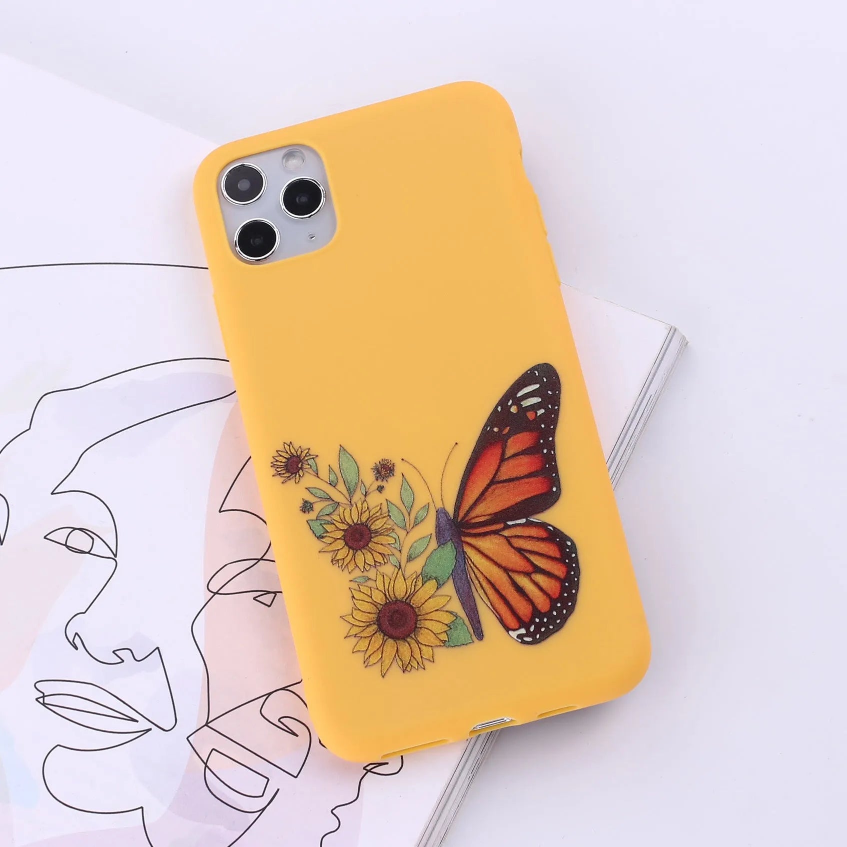 Slim TPU mobile phone case for iPhone on a table, showing one of 14 available colour options.