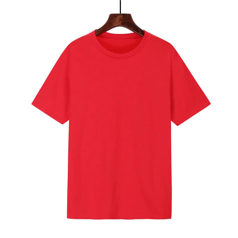 Man wearing a black loose-fit cotton T-shirt with short sleeves, showcasing casual style.