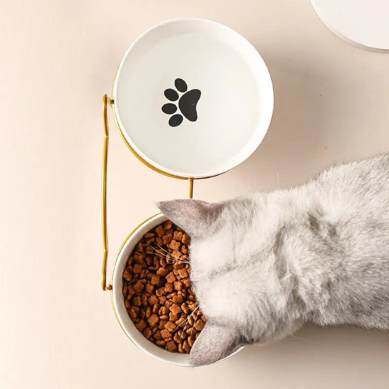 White ceramic cat bowl with decorative patterns on iron frame with cat ear details