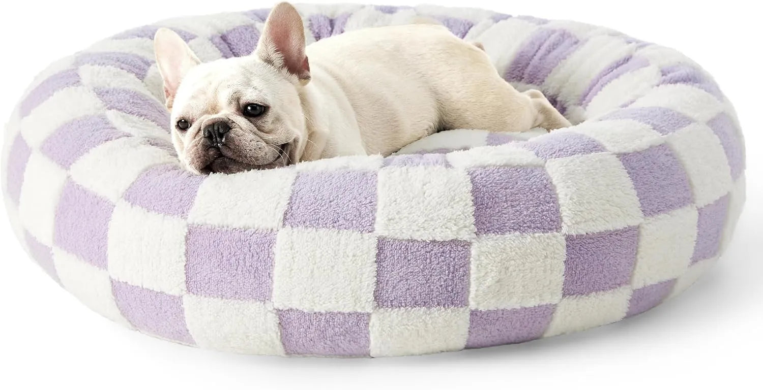 Round plaid-patterned dog bed on a floor, shown in a blue and white colour variant.
