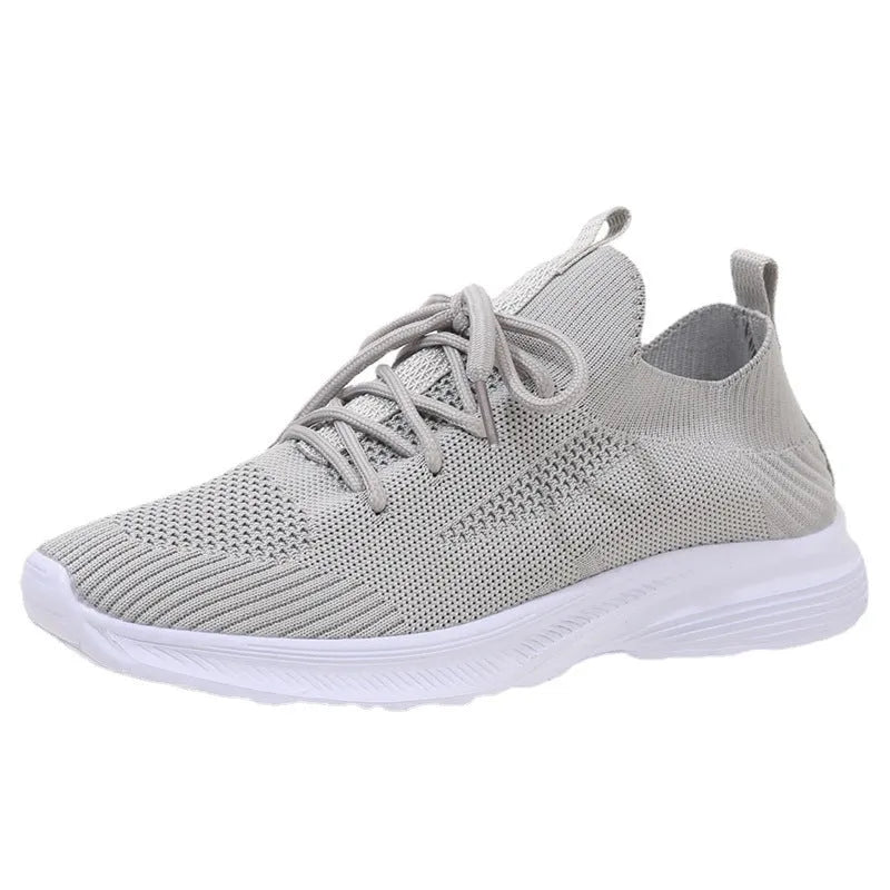 Women's low-top mesh running shoes in creamy white with a rubber sole and round toe.