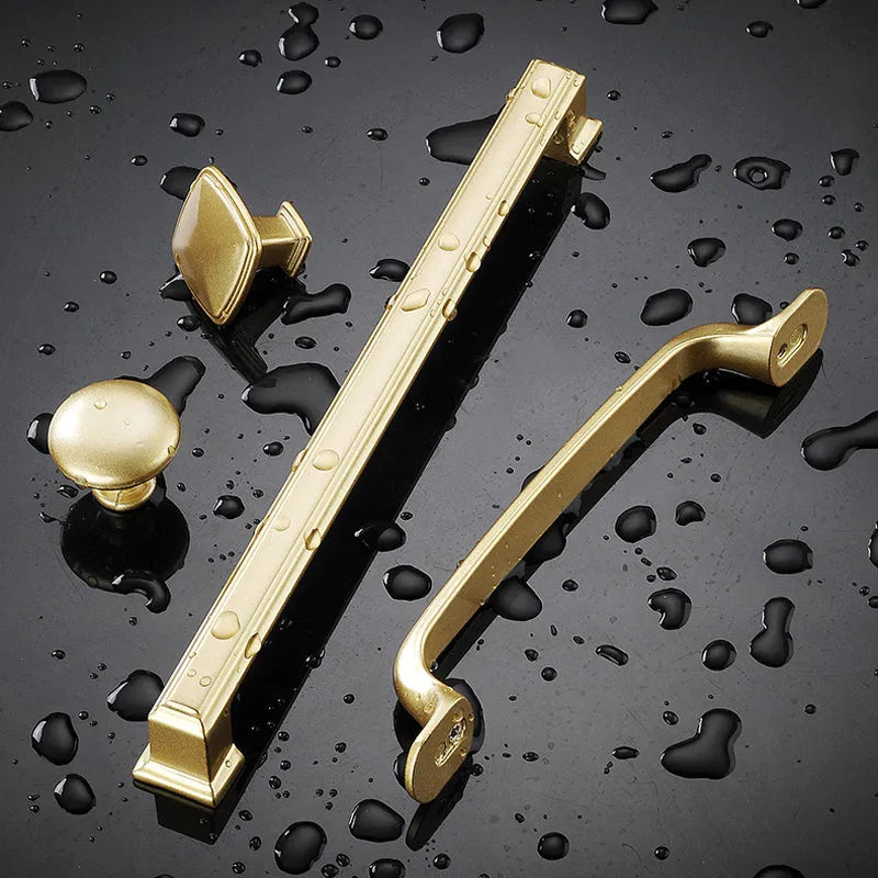 Gold T-shaped aluminium cabinet handle for single hole mounting.