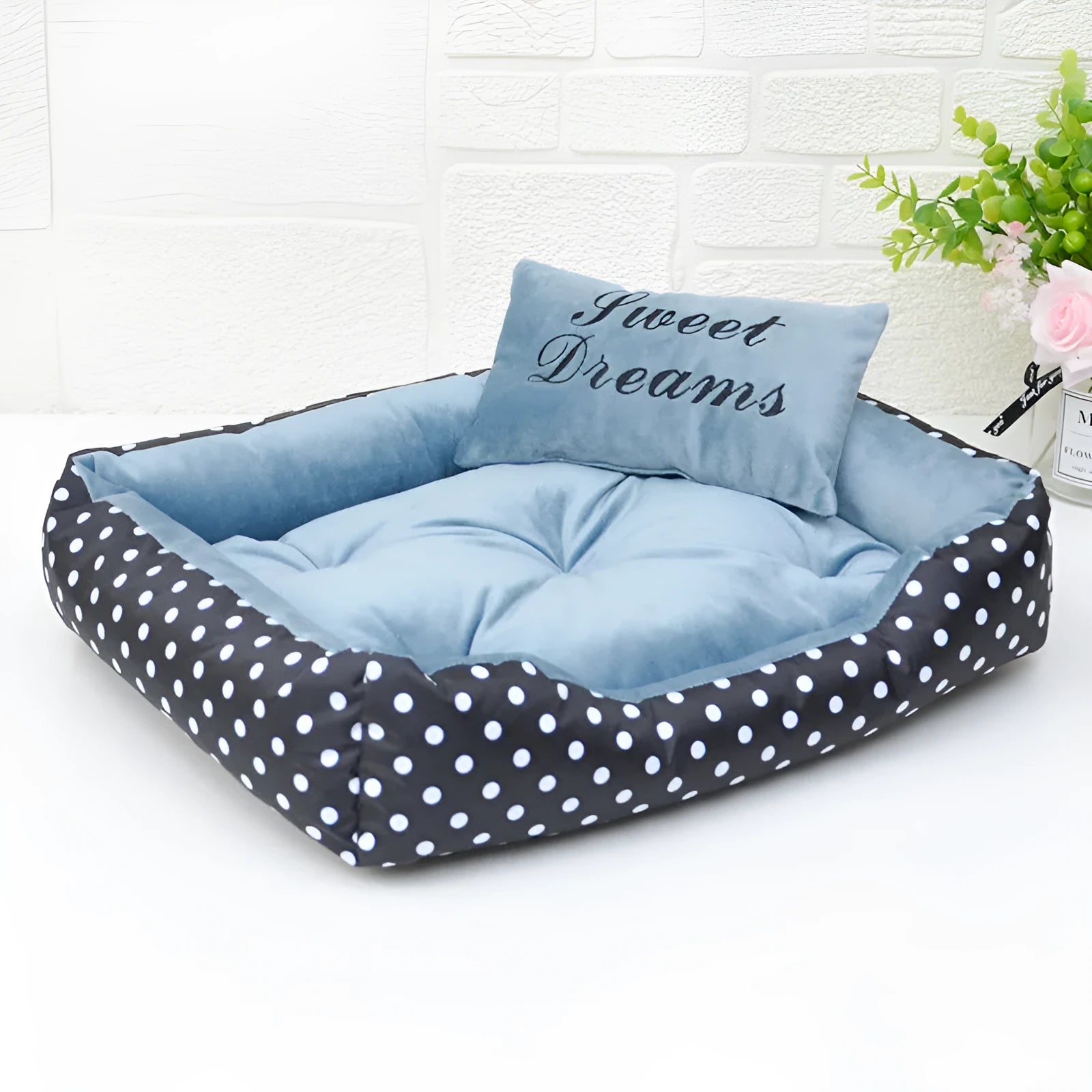 Small polka dot print dog bed with a square cushion, shown in grey colour.