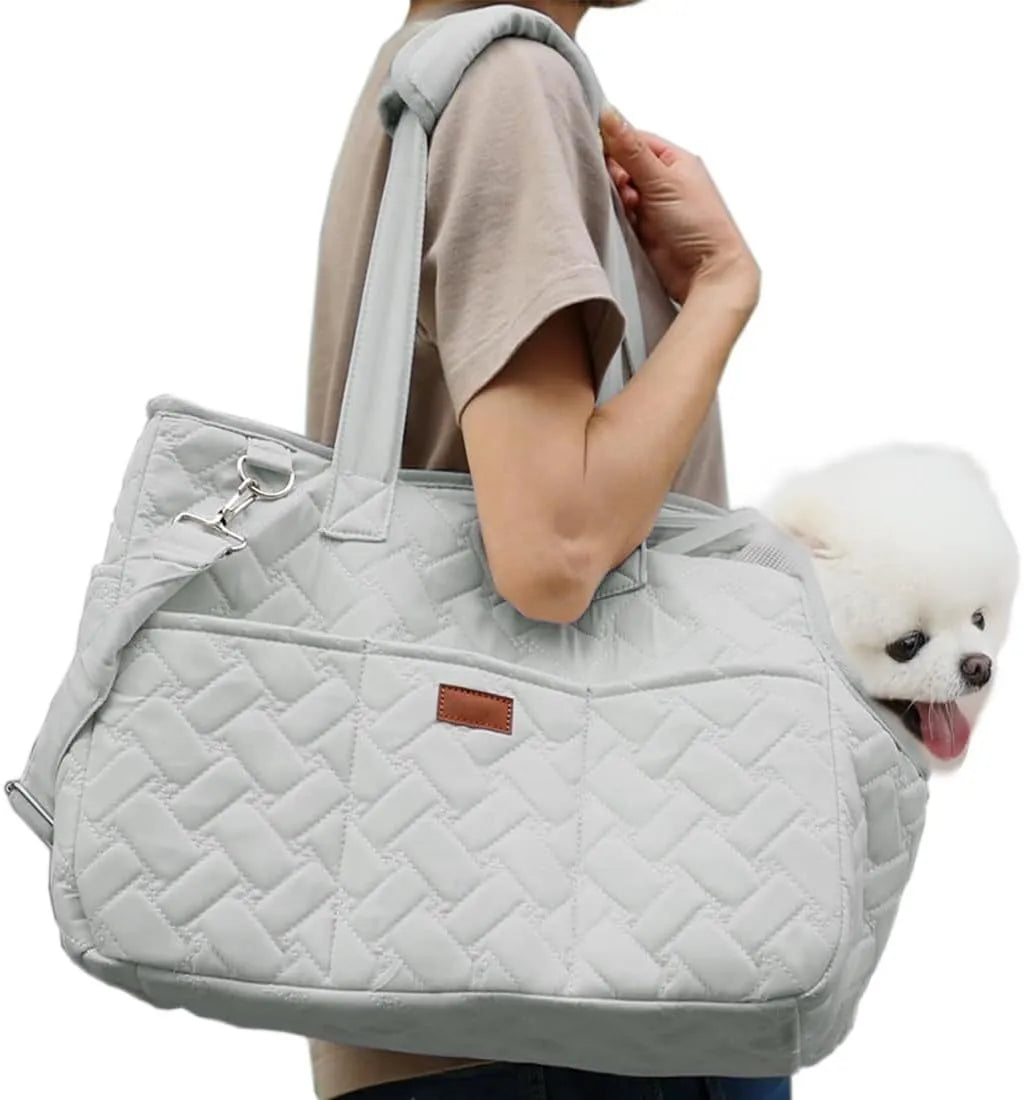 Grey handbag-style pet carrier with mesh panels and a soft cushion inside for a small dog.