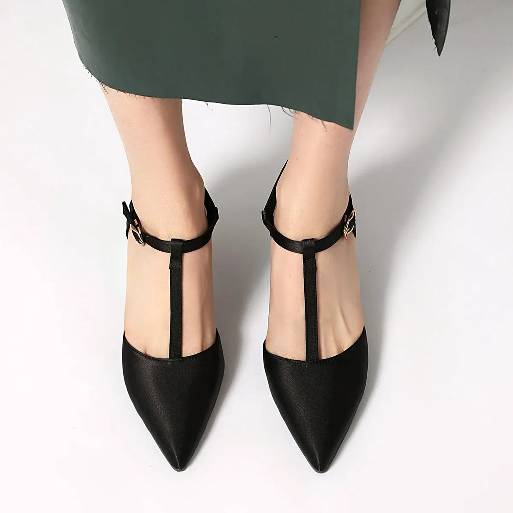 Women's pointed T-strap high heels in top grain leather, black colour, side view on plain background