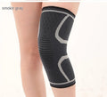 Double corrugated non-slip sports knee pads in various colours on a grey background.