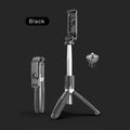 Black and white adjustable Bluetooth selfie stick tripod with wireless remote control extended next to smartphone.