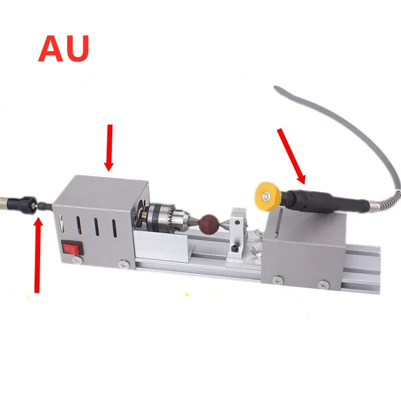 Mini silver metal manual woodworking lathe with carving knives on a workbench.