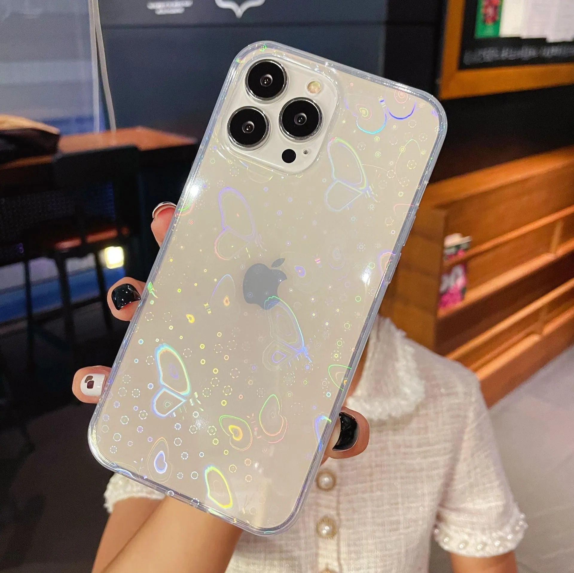 Transparent silicone iPhone case with laser butterfly pattern showing phone compatibility