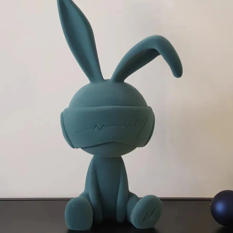 Suede blindfold rabbit resin table ornament in chosen colour on a wooden surface.