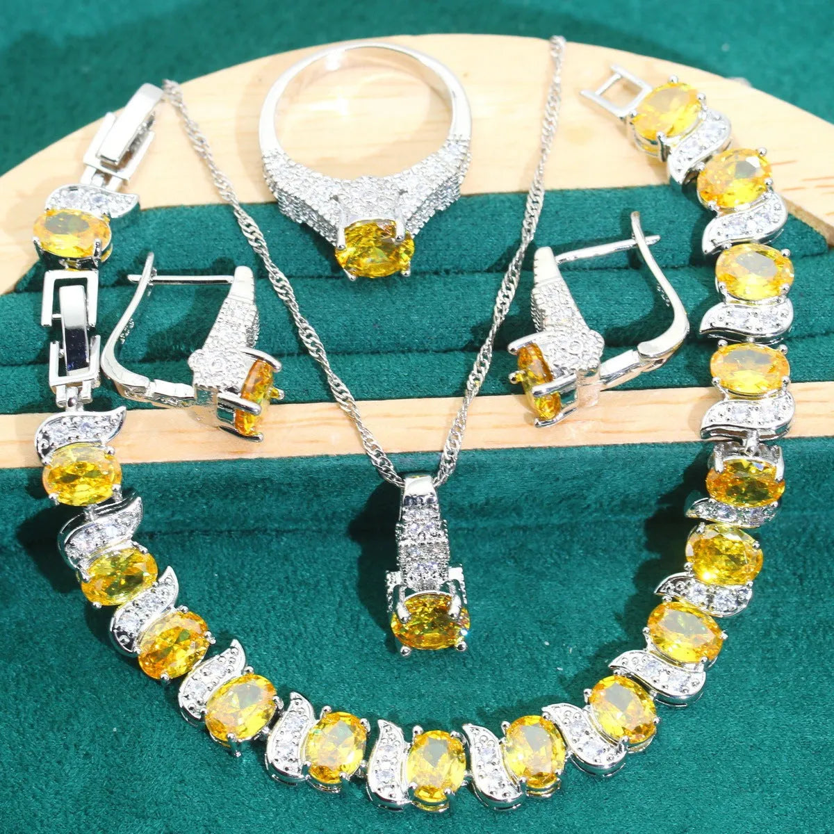 Four-piece bridal jewellery set showing zircon necklace, bracelet, earrings and ring with water wave chain design