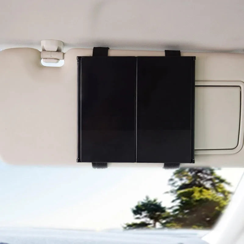 Silver folding car makeup mirror shown open and closed, next to a car visor.