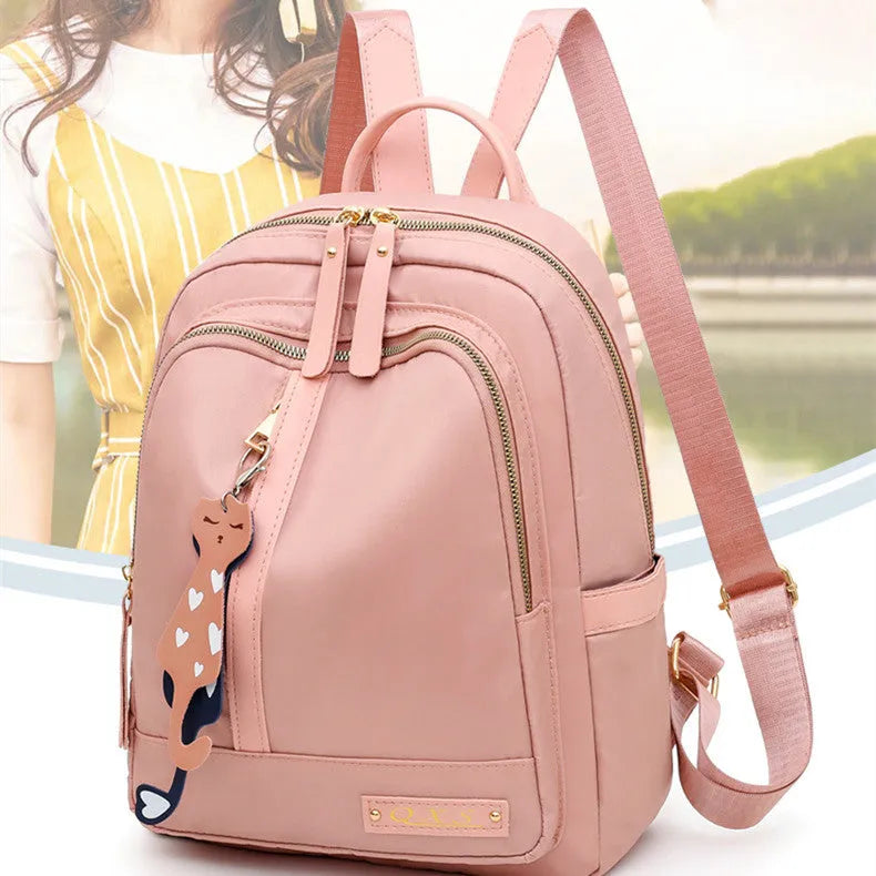 Women's black nylon backpack with double shoulder straps and organisational compartments