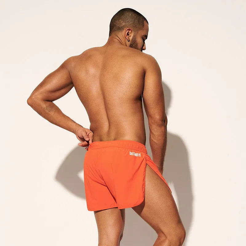 Men's loose fit beach shorts in polyester available in orange red, fluorescent green and black colours