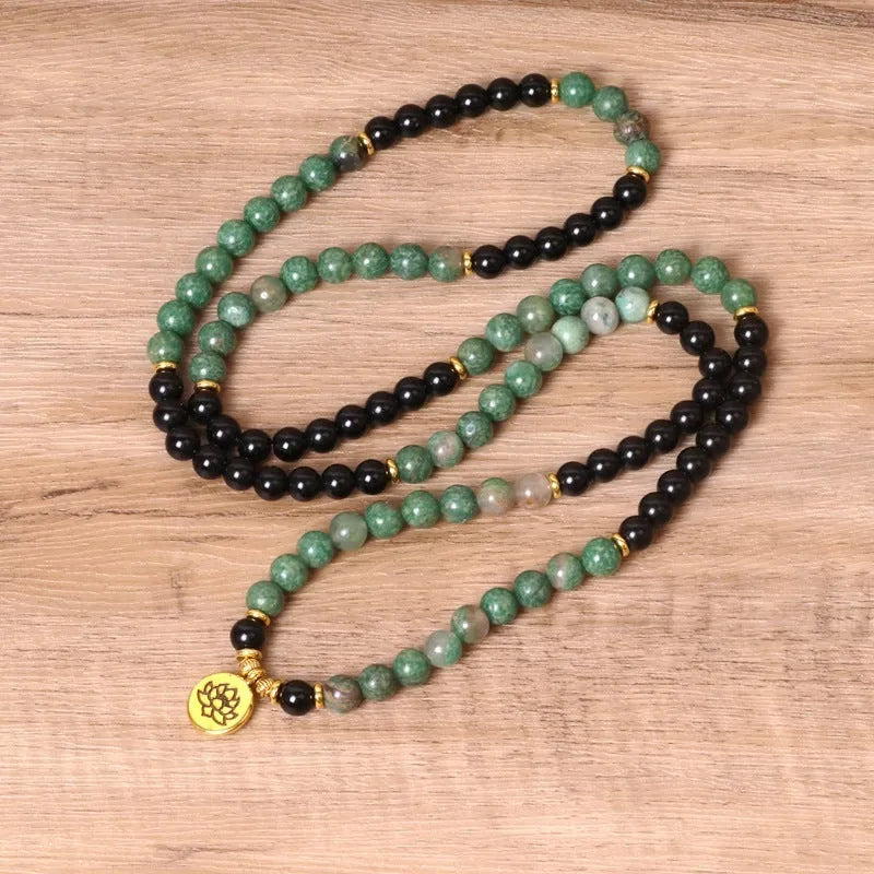 Women's green and black alloy elastic beaded bracelet on a wrist, showing natural style design.