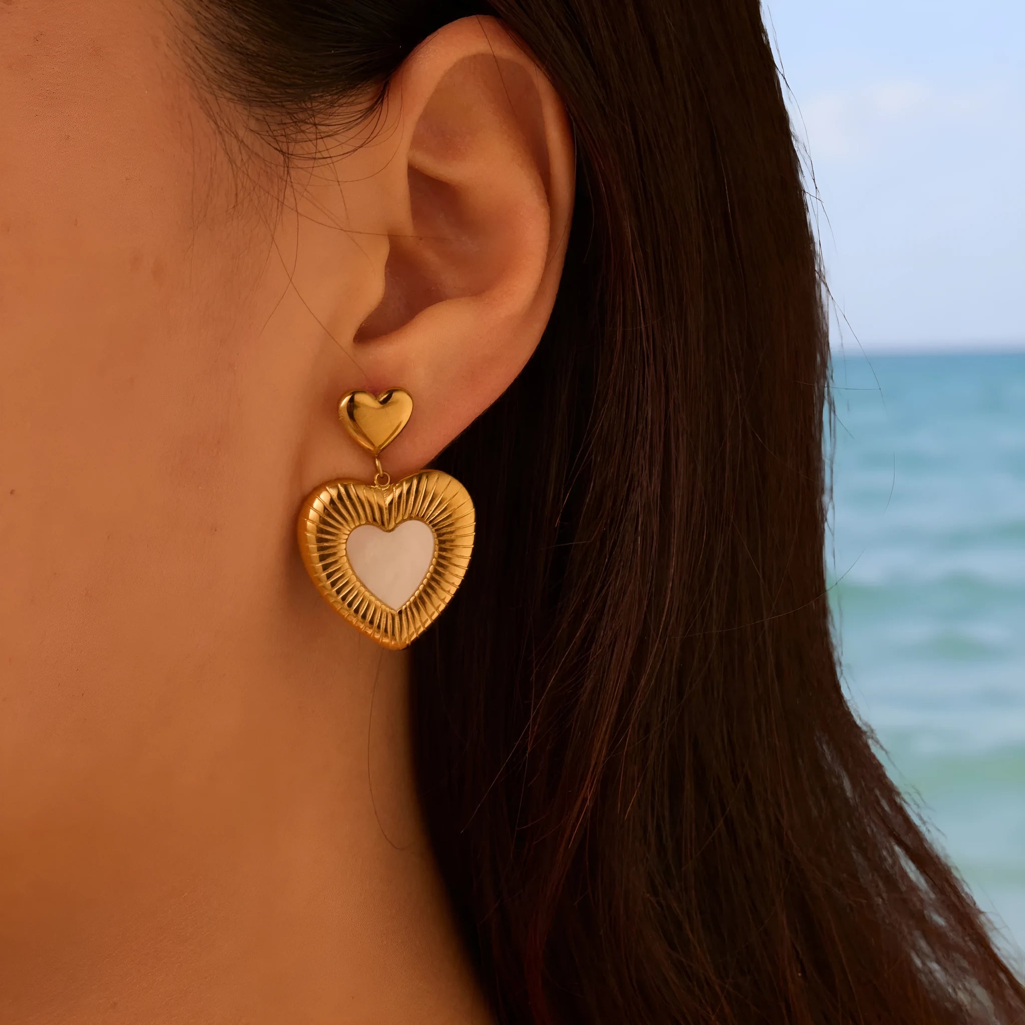 Gold heart-shaped stainless steel earrings with 18K electroplated finish for women's fashion wear