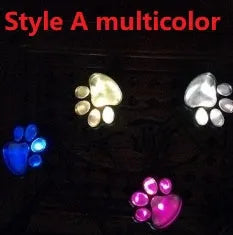 Black solar powered animal paw print LED garden lights set with four paw shapes and solar panel