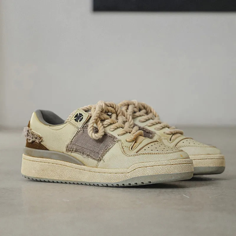 Beige low-top casual skateboard shoes with round toe and front lace-up on a rubber sole.