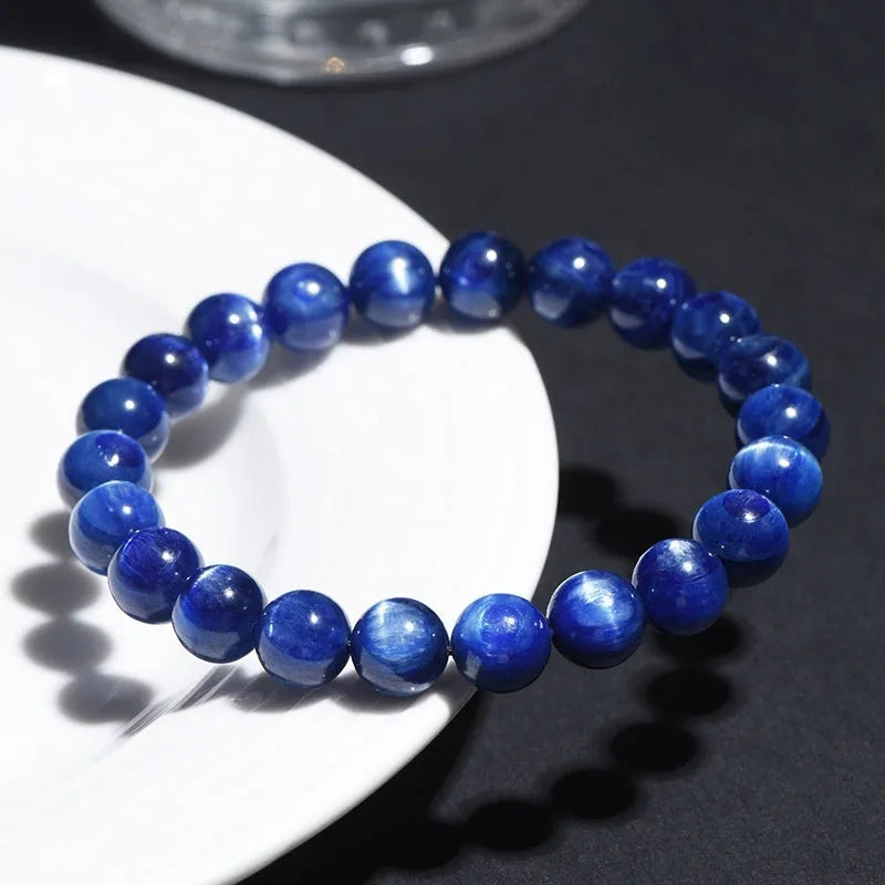 Natural blue crystal ball bracelet with geometric shape and Ruyi detail on a white background.