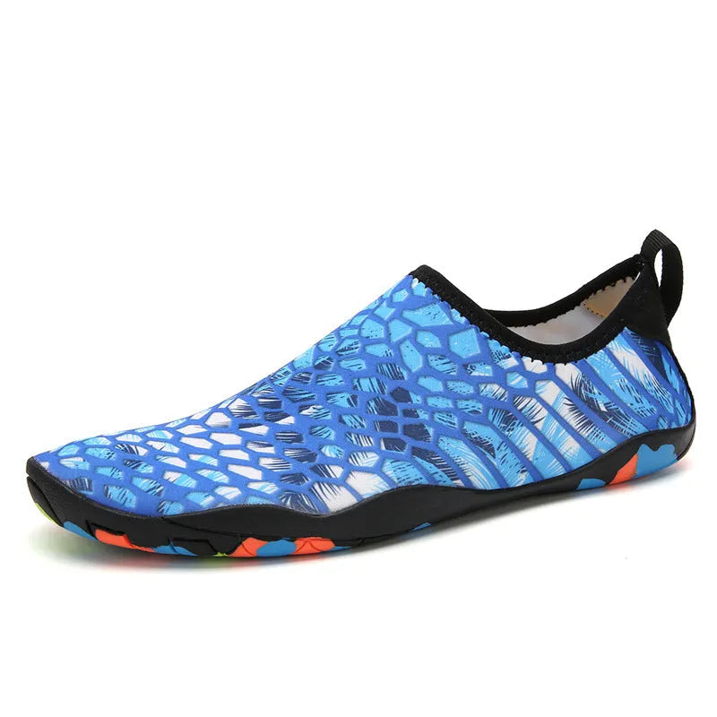 Blue Lycra beach wading shoes with EVA midsole on a sandy beach